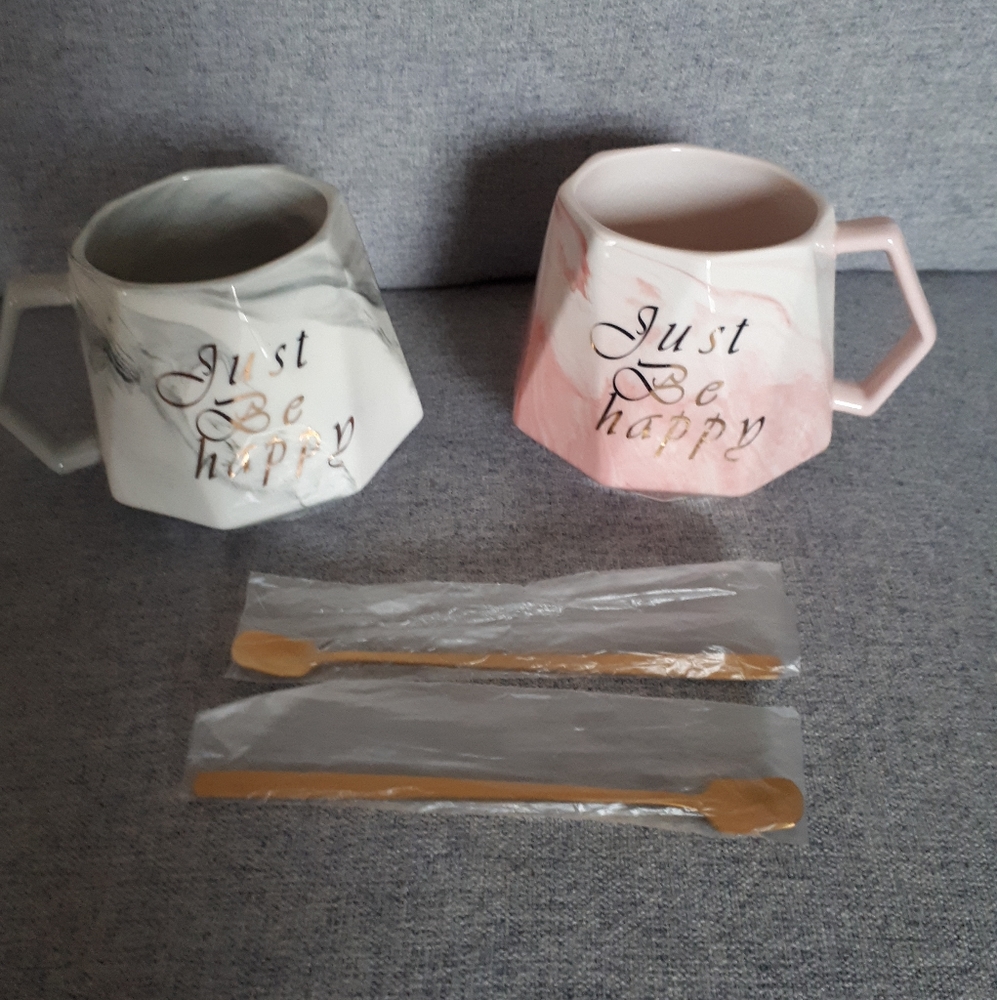 A set of 2 Awanber not a day over fabulous coffee mugs with 2 tiny spoons.